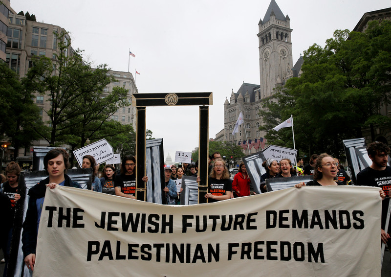 Marchers with banner that reads The Jewish future demands Palestinian freedom