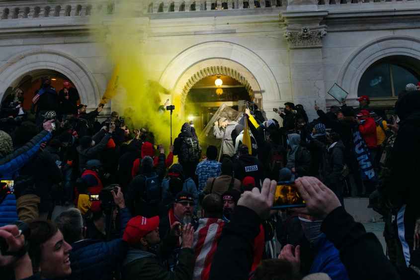 Law enforcement use a smoke grenade in attempt to push back protesters at the U.S. Capitol building during a protest in Washington, D.C., U.S., on Wednesday, Jan. 6, 2021. The U.S. Capitol was placed under lockdown and Vice President Mike Pence left the floor of Congress as hundreds of protesters swarmed past barricades surrounding the building where lawmakers were debating Joe Biden's victory in the Electoral College. Photographer: Eric Lee/Bloomberg via Getty Images