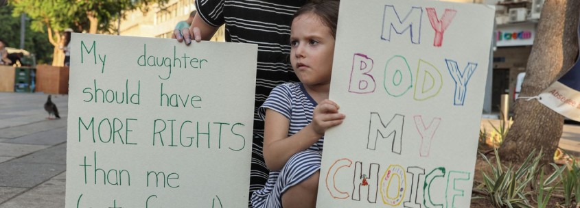child holds protest sign