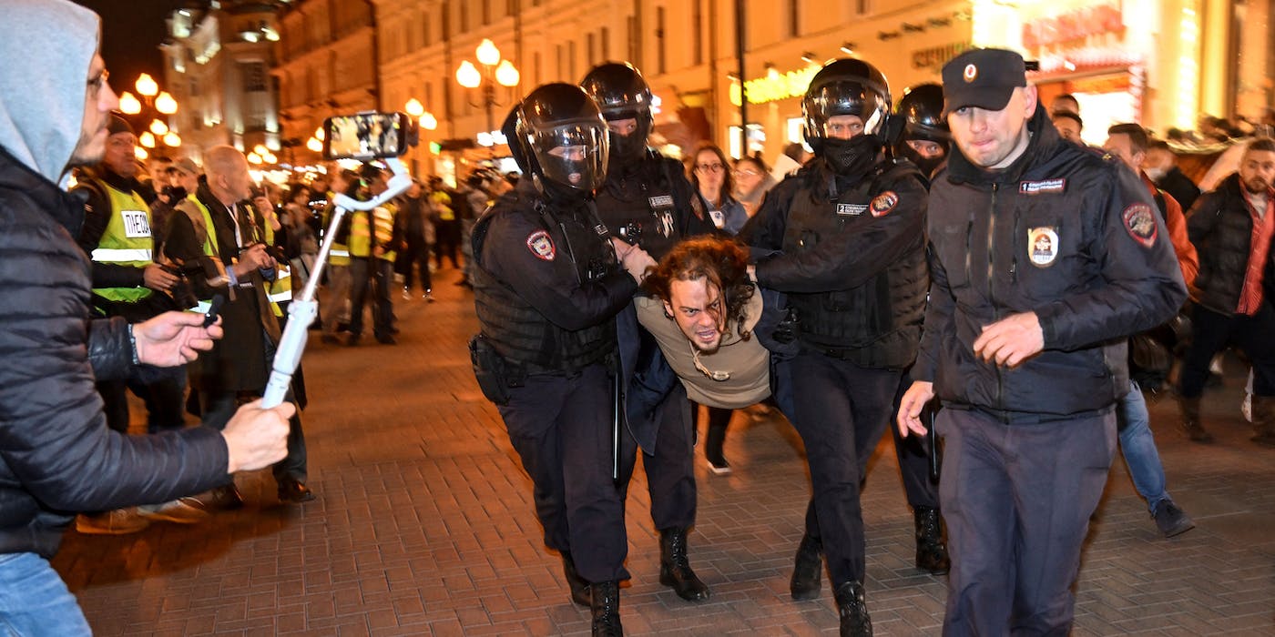 Police officers detain a man in Moscow on September 21, 2022, following calls to protest against partial mobilisation announced by President Vladimir Putin. - President Vladimir Putin called up Russian military reservists on September 21, saying his promise to use all military means in Ukraine was "no bluff," and hinting that Moscow was prepared to use nuclear weapons. His mobilisation call comes as Moscow-held regions of Ukraine prepare to hold annexation referendums this week, dramatically upping the stakes in the seven-month conflict by allowing Moscow to accuse Ukraine of attacking Russian territory. (Photo by Alexander NEMENOV / AFP) (Photo by ALEXANDER NEMENOV/AFP via Getty Images)