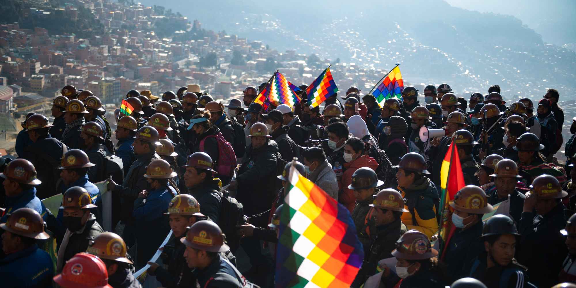 25 August 2022, Bolivia, La Paz: Supporters of President Arce's government march with flags and mining helmets during a rally in support of the government. "We are starting this big rallyfor the country and democracy," the Bolivian leader wrote on Twitter. Arce had called for the rally. He said it was intended to send a signal against the "right-wing coup plotters." Photo: Radoslaw Czajkowski/dpa (Photo by Radoslaw Czajkowski/picture alliance via Getty Images)