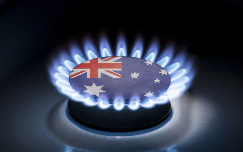 Burning gas burner of a home stove in the middle of which is the flag of the country of Australia. Image: iStock