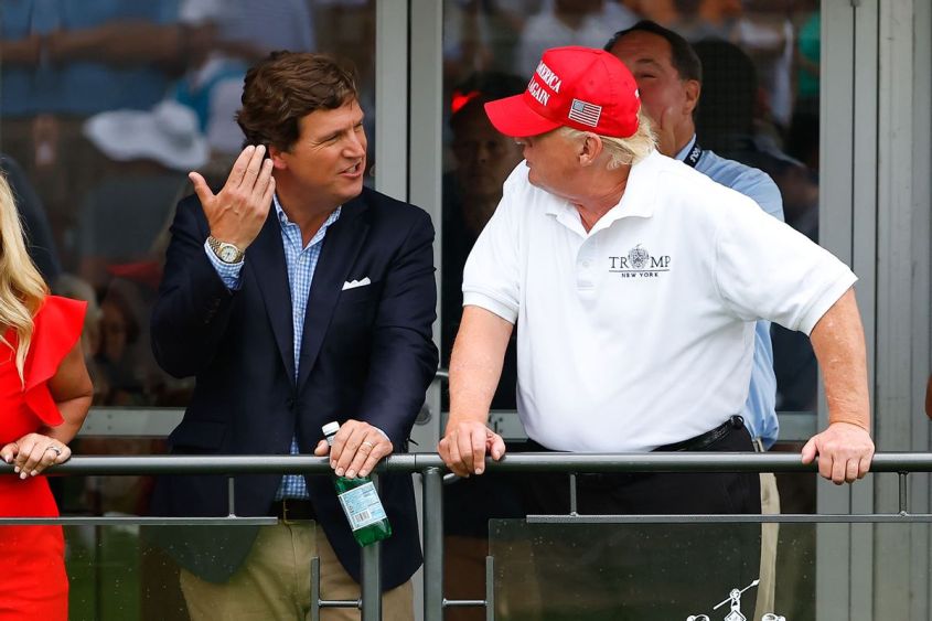 Former President Donald Trump and Tucker Carlson chat during the 3rd round of the LIV Golf Invitational Series Bedminster on July 31, 2022 at Trump National Golf Club in Bedminster, New Jersey. (Rich Graessle/Icon Sportswire via Getty Images)