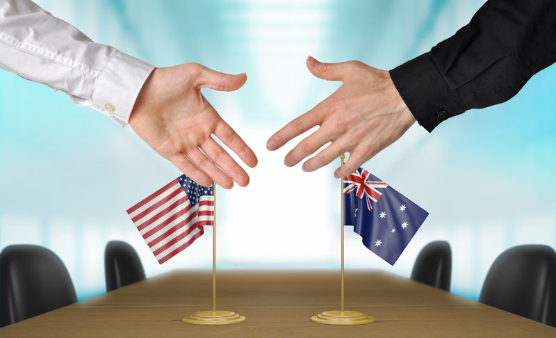 United States and Australia extending their hands for a handshake.