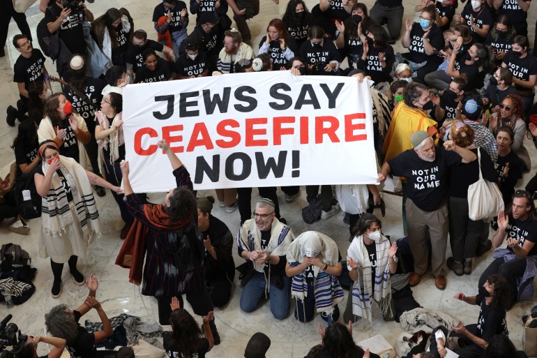 WASHINGTON, DC - OCTOBER 18: Protesters hold a demonstration in support of a cease fire in Gaza in the Cannon House Office Building on October 18, 2023 in Washington, DC. Members of the Jewish Voice for Peace and the IfNotNow movement staged a rally to call for a cease fire in the Israel–Hamas war. Alex Wong/Getty Images/AFP (Photo by ALEX WONG / GETTY IMAGES NORTH AMERICA / Getty Images via AFP)