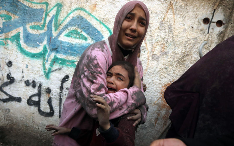 Rafah, Gaza. 12th Dec, 2023. Young Palestinians react following Israeli bombardment at Al-Shaboura refugee camp in Rafah in the southern Gaza Strip on Tuesday, December 12, 2023. At least 22 people have been reportedly killed, including seven children, in the bombing by Israel in Rafah on Tuesday. Global calls for a ceasefire have been ignored by Israel and the United States, as humanitarian aid operations have collapsed warning of starvation and disease amongst the Gaza population. Image: Alamy/ Ismael Mohamad/UPI Credit: UPI/Alamy Live News